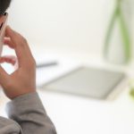 Close-up view of businessman making phone call with his customer